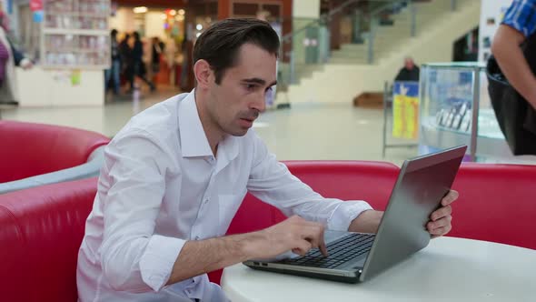 Man at Work with a Laptop Trying To Avoid the Problem