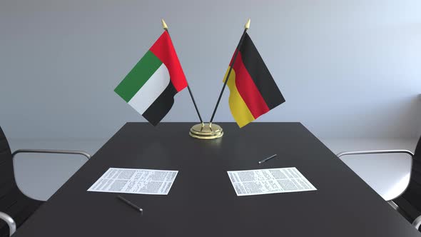 Flags of the United Arab Emirates and Germany on the Table
