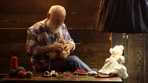 Seamstress Senior Man, Tailor Pensioner. Old Designer for Toys in Her Workshop, Sewing Concept