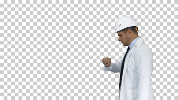 Portrait of architect wearing hardhat looking at watch like