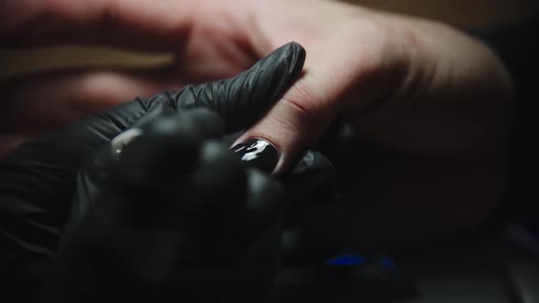 Male Manicure  Nail Master Applying Black Nail Polish