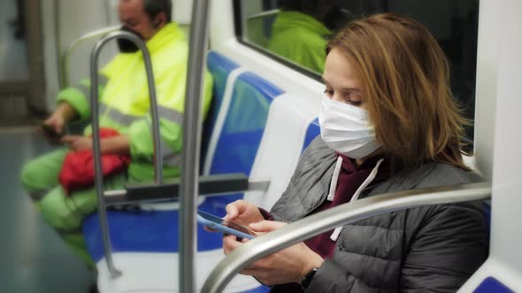 Woman Using Mobile Phone in Public Underground Train