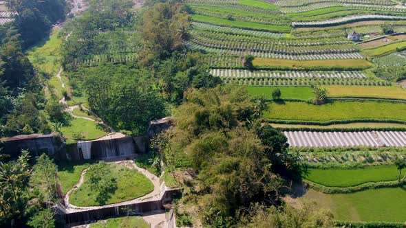 Aerial panorama of rural landscape reveal suspension Jokowi Bridge Java