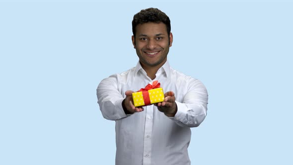 Smiling Indian Man Handing Gift Box