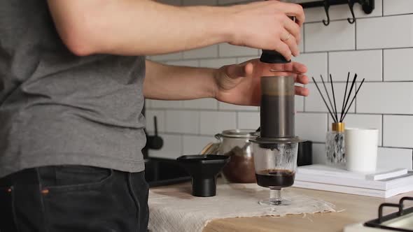 Barista Makes Aeropress Step By Step. Squeeze Out Coffee.