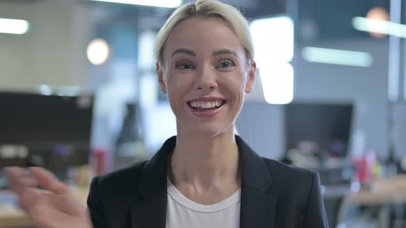 Talking Businesswoman Doing Video Chat in Office