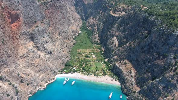 Deep Rocky Narrow Valley by the Turquoise Sea