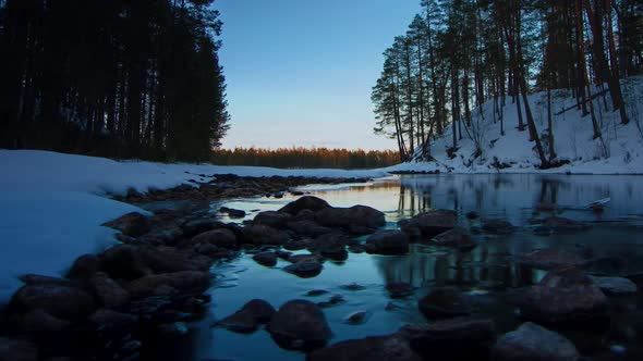 DAY TO NIGHT SLIDER TIMELAPSE TILT UP from a stream to the Aurora Borealis