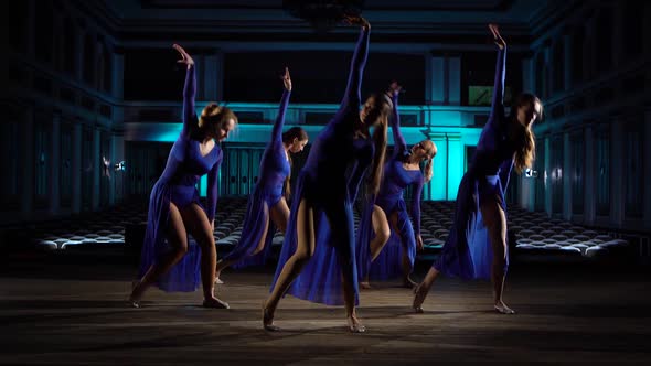 Group Young Skillful Ballerinas Dancing Modern Ballet on the Stage of Large Hall. Girls Looking at