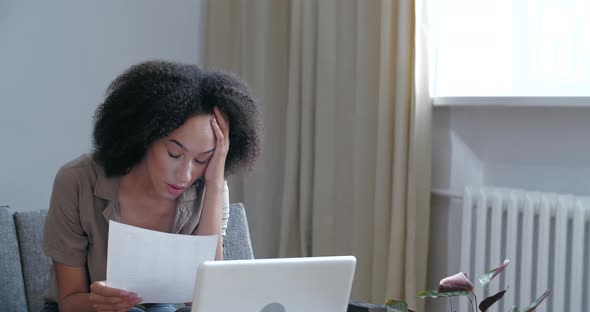 Close Up African Anger Shoked Stressed Woman Picks Up Letter Paper Mail, Reads Bad News of Divorce