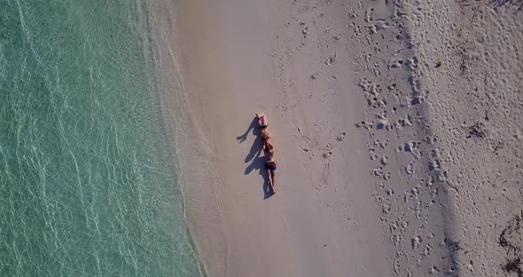 Young boy and girl in love dating on vacation live the dream on beach on white sand background 4K