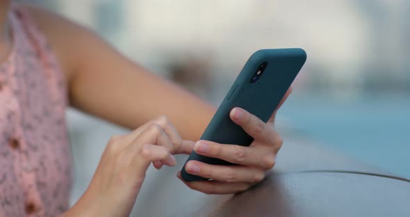 Woman use of smart phone in city