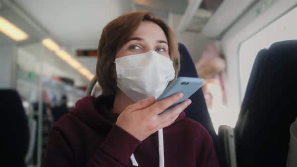 Woman Wearing Mask in Subway Train Having Mobile Conversation on Speakerphone