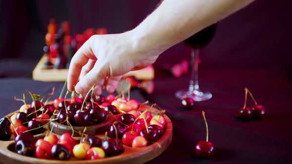 Close Up of Compartmental Dish of Different Varieties of Sweet Cherries with Water Drops on Table
