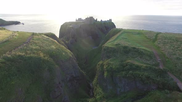 Aerial view of a valley and the Dunnottar Castle