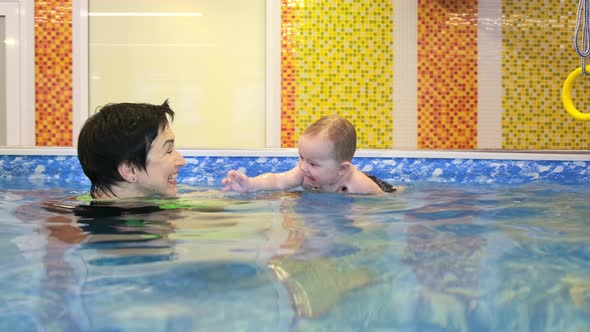 Coach Teaches Girl in Pool