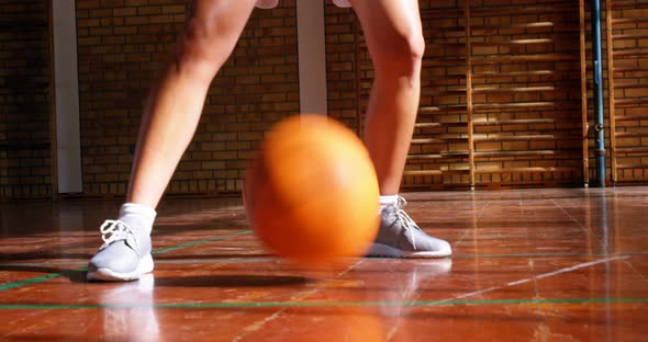 Determined schoolgirl practicing basketball 4k