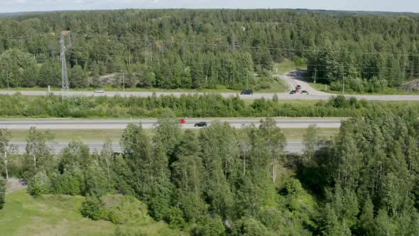 Fast aerial shot following cars driving quickly on a Finnish motorway near Kerava.