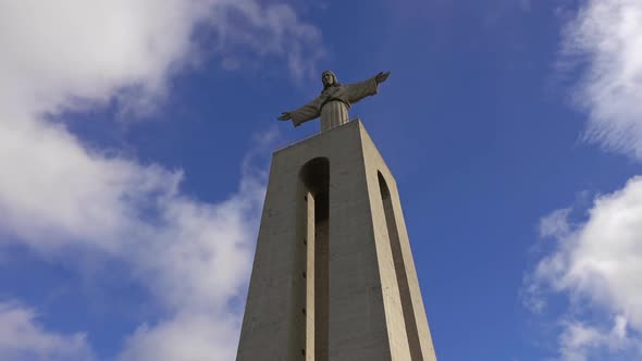 Christ King Statue Against a Blue Sky with Clouds