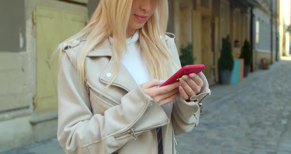 Attractive Young Woman Using Phone in the City Center. Chatting with Friends, Girl Using Cellphone