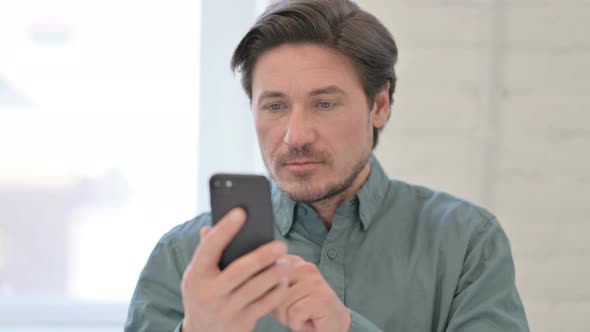 Middle Aged Man using Smartphone