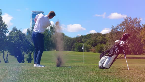 Male Player Is Hitting the Golf Ball with Strength