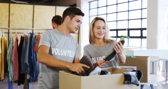 Volunteers going through donation box of clothes