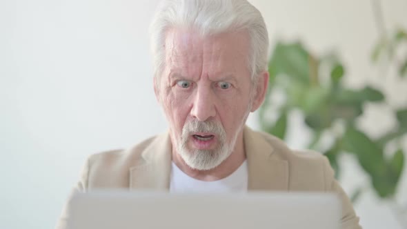 Close Up of Old Man Reacting to Loss While Using Laptop
