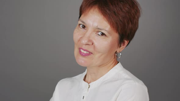 Portrait of Short Haired Mature Woman on Studio Background