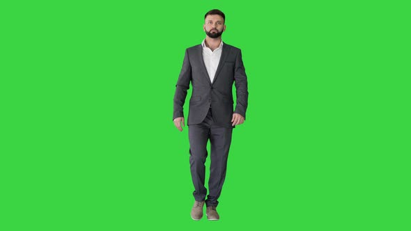 Serious Businessman with a Beard and in Formal Suit Walking on a Green Screen, Chroma Key.