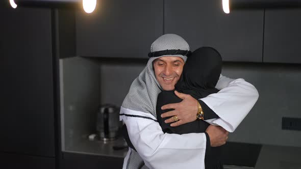 Portrait of Happy Loving Middle Eastern Man in Chequered Keffiyeh Hugging Woman Smiling