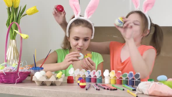 Two Cute Girls Play with Decorated Easter Eggs