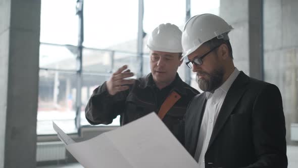 Two Engineers Meet At Construction And Consult Building Project