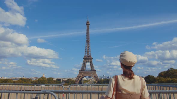 Young woman at the Eiffel Tower in Paris