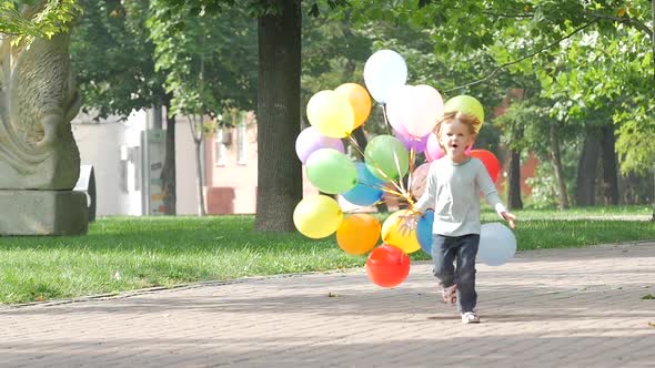 Emotional Little Girl Runs with Multicolored Balloons, Slow Motion