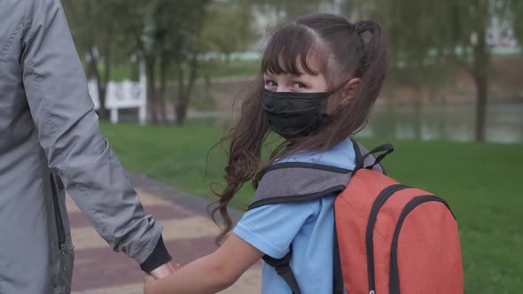 Schoolgirl in a protective mask. 