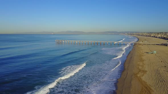 Aerial drone uav view of a pier over the beach and ocean.