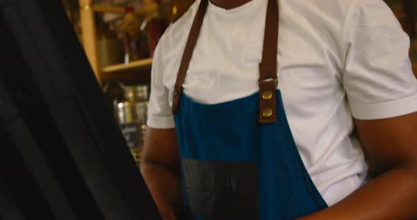 Male staff working on computer at counter 4k