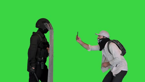Aggressive Protester Shooting Riot Police on Smartphone on a Green Screen Chroma Key