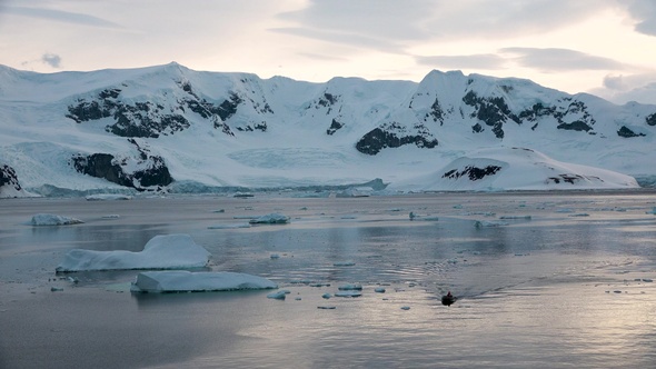 Colorful Mountains at Sunset in Antarctica. Mirror reflection in Ocean Water. Beauty world, holidays