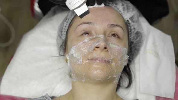 Cosmetologist Make Ultrasonic Face Cleaning on Woman Face in Beauty Clinic Salon