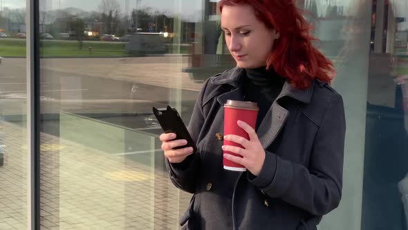 Lifestyle Shot of Young Woman with Cup of Coffee and Smartphone