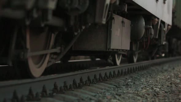 The Wheels of Old Train on the Railway Track Passing By Camera. Close Up Shot