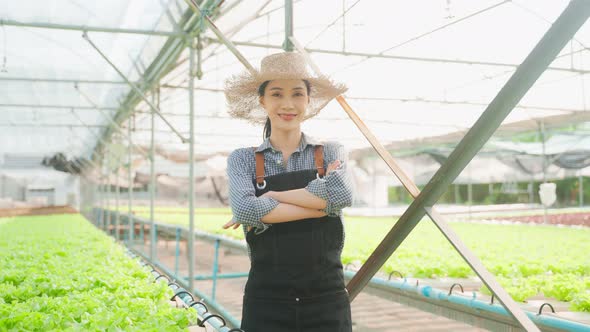 Portrait of beautiful girl farmer working in vegetable hydroponic farm.