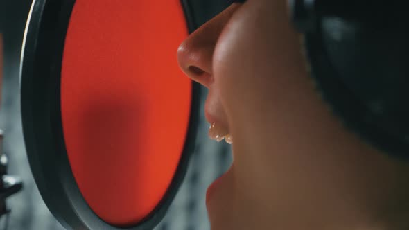 Mouth of Female Singer Singing Song in Sound Studio