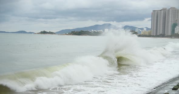 Cloudy Weather, Rain, Large Gray Clouds, Gloomy Weather, Sea Waves Break on the Shore of the City