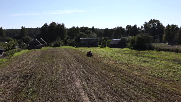 Farmer Digs Potatoes with a Small Tractor