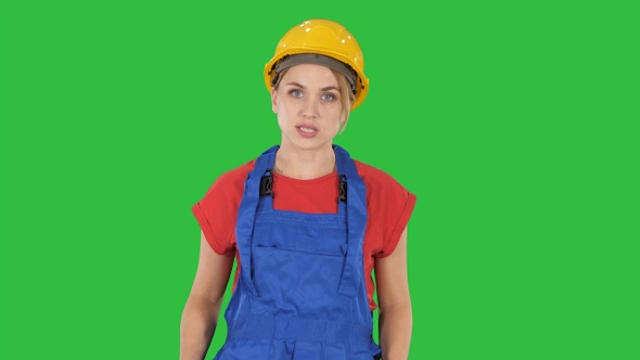 Woman in construction outfit talking to camera while walking