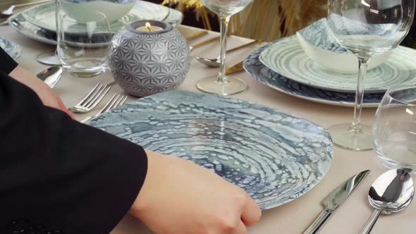 Close Up of Woman Setting Table