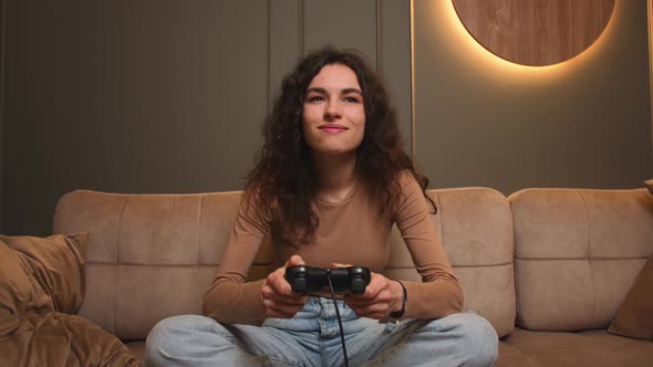 Smiling Woman Playing a Video Game at Home